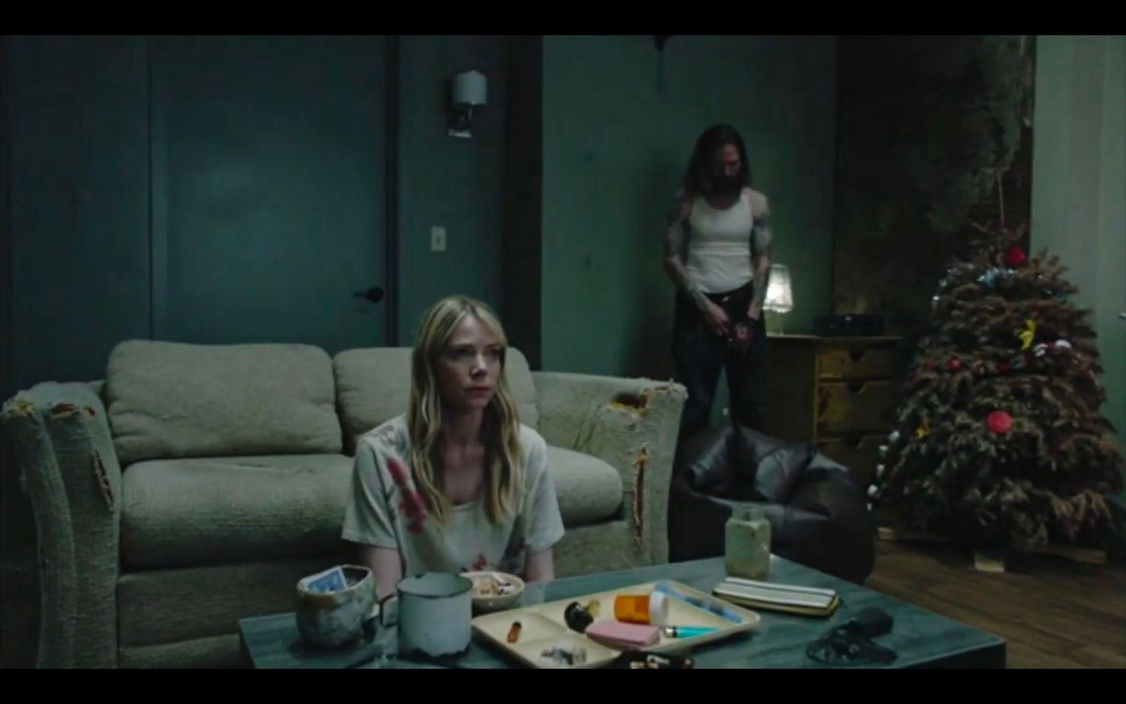 a woman sitting on a couch in a living room