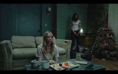 a woman sitting on a couch in a living room