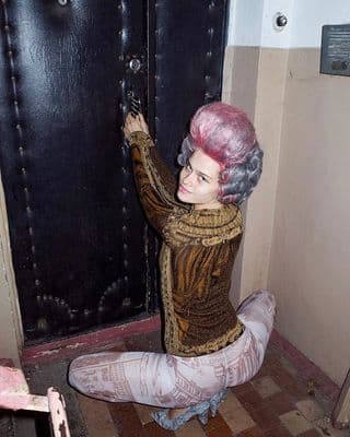 a statue of a woman sitting on the ground