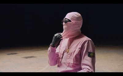 a person wearing a pink outfit and a necklace