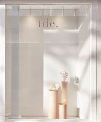 a window display with vases and flowers in it