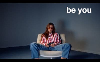 a woman sitting in a chair with a cell phone