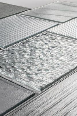 a close up of a tiled floor with water on it