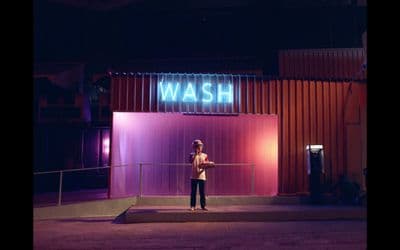 a person standing in front of a building at night