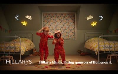 two children in red pajamas dancing in a bedroom