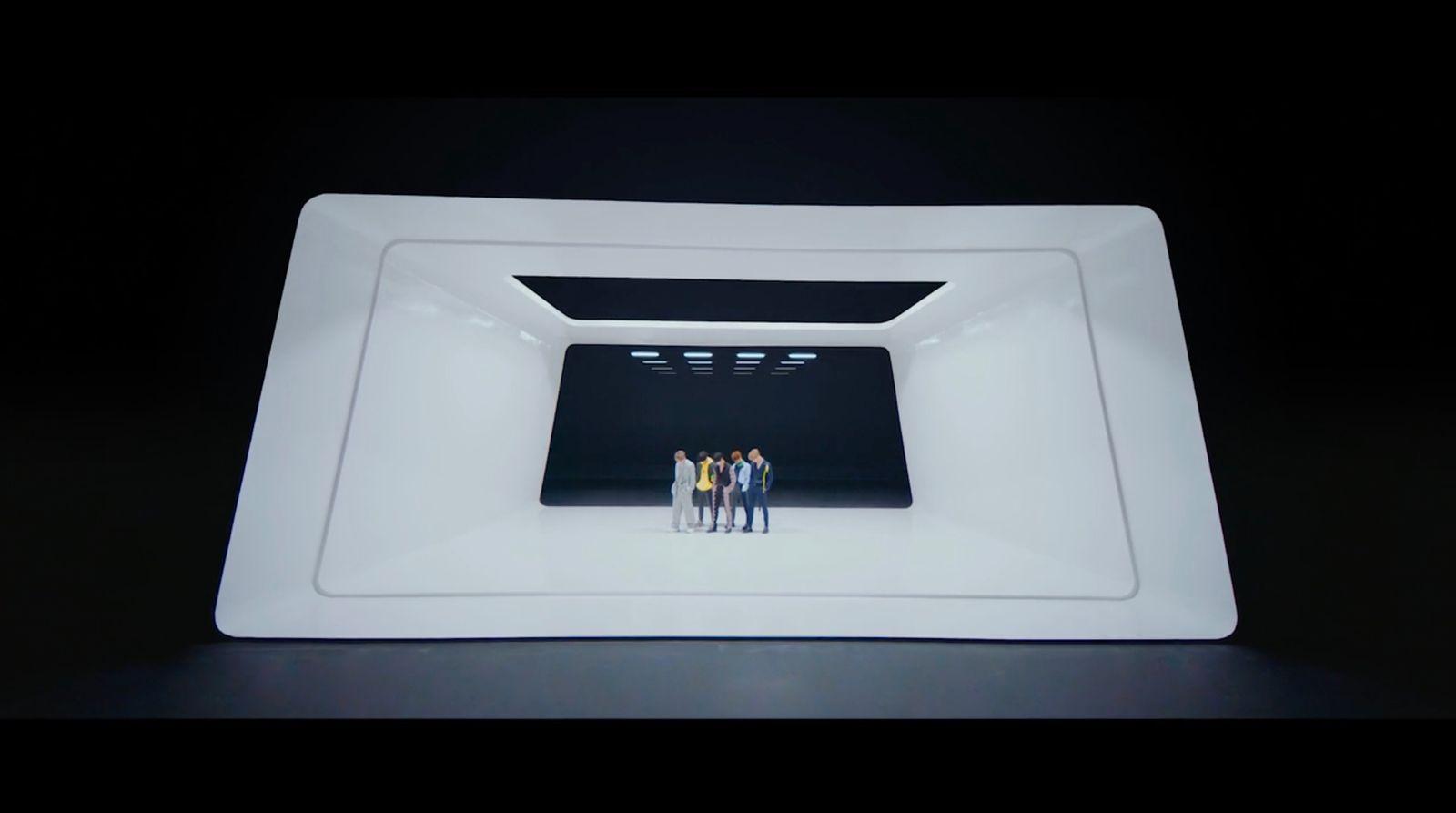 a group of people standing inside of a white bowl