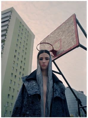 a woman standing in front of a basketball hoop