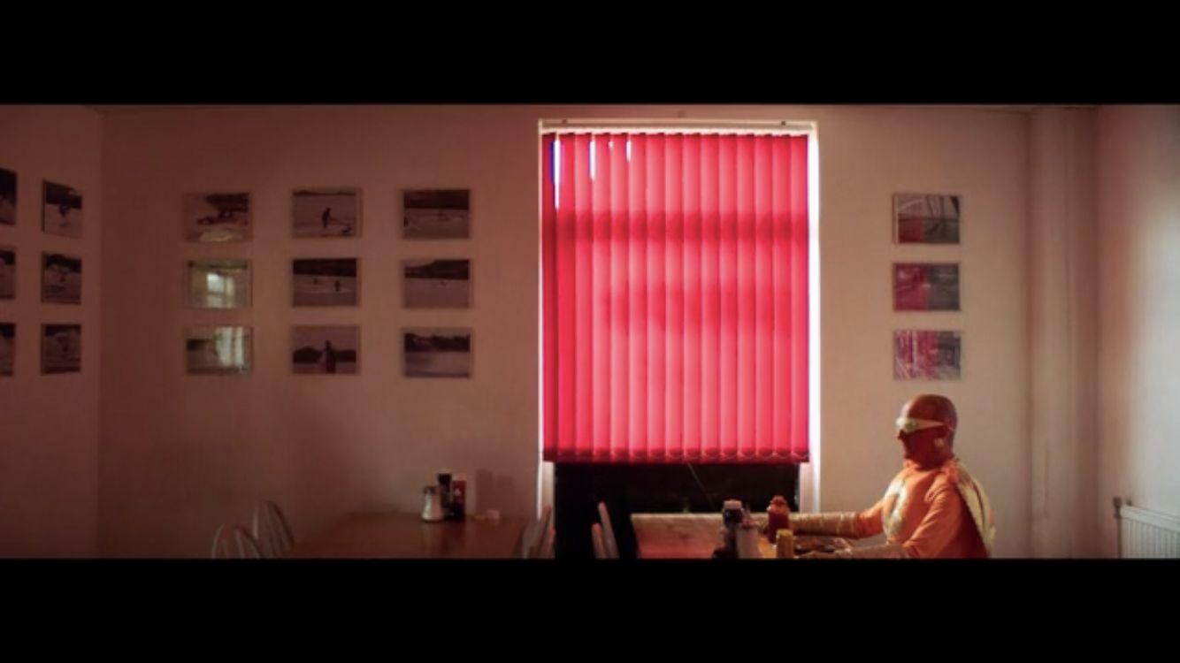 a person sitting at a table in front of a window