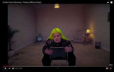 a person with yellow hair sitting in a room
