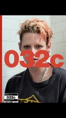 a woman with red hair and a black shirt