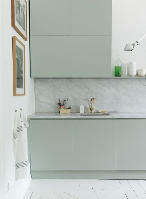 a kitchen with a marble counter top next to a sink