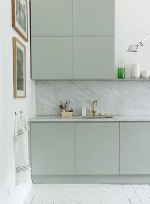 a kitchen with a marble counter top next to a sink