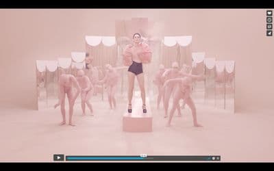 a woman standing on a pedestal in front of a group of mannequins