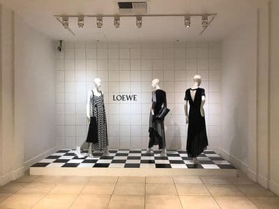 three mannequins in a room with a checkered floor