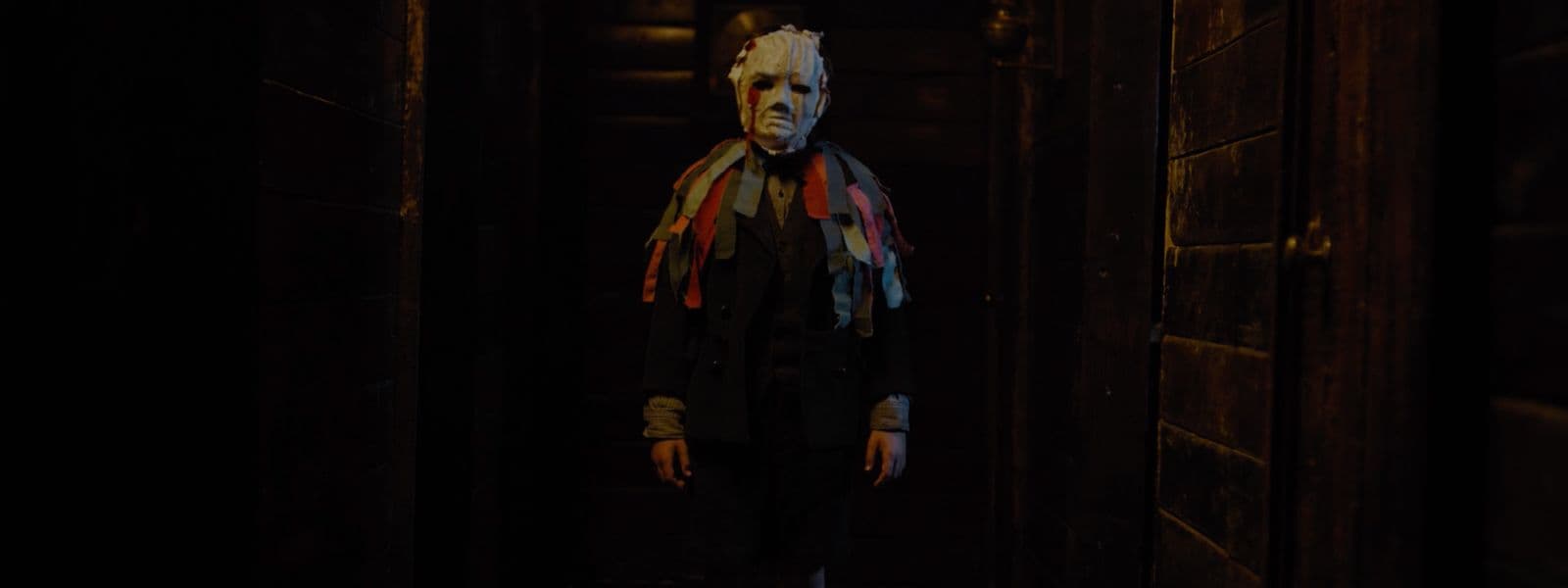 a creepy looking person with a scarf around his neck