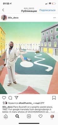 a man in a white suit standing in front of a painting