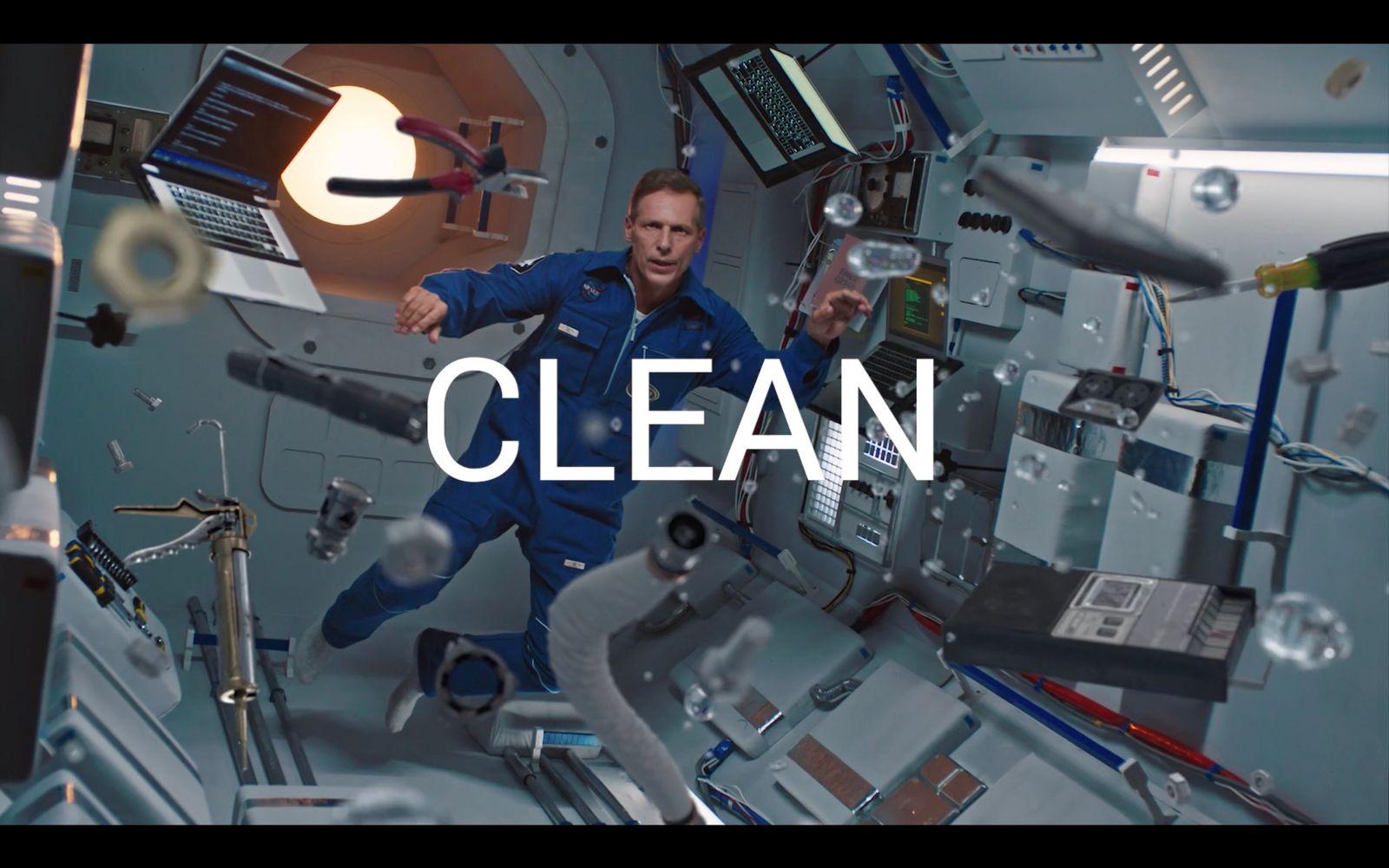 a man in a space station with the words clean