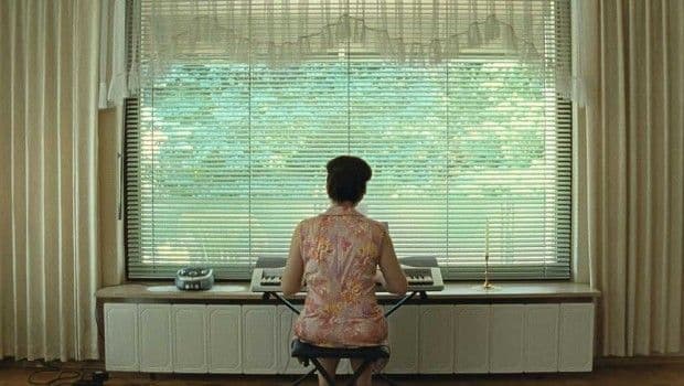 a woman sitting at a desk in front of a window