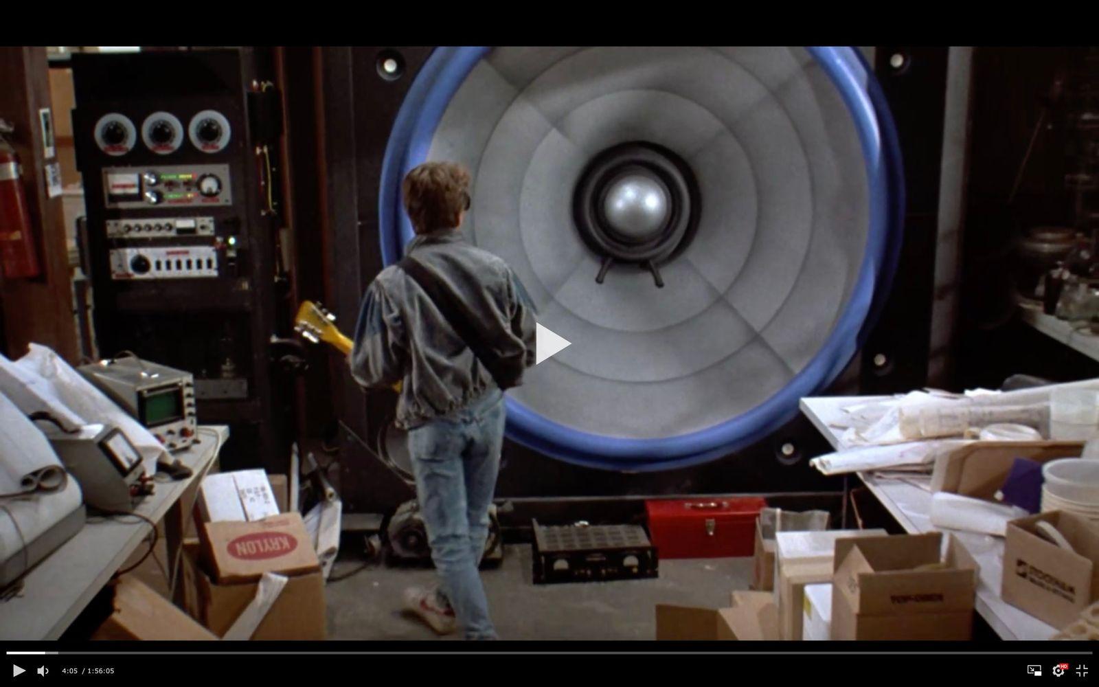 a man standing in front of a large speaker