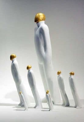 a group of white mannequins with gold accents