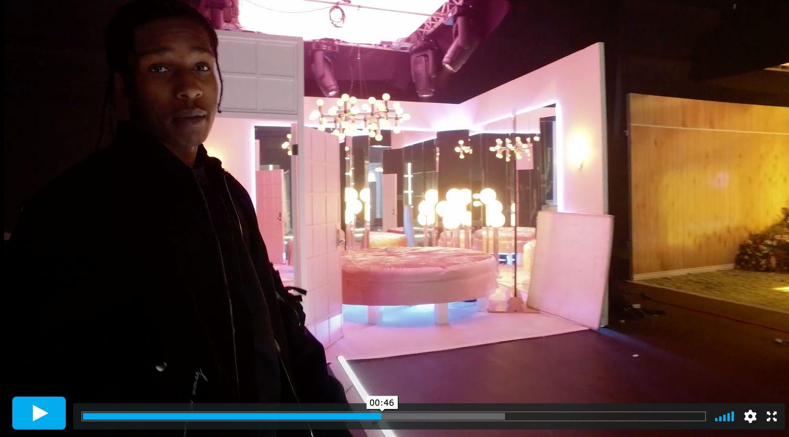 a man standing in front of a room with a chandelier