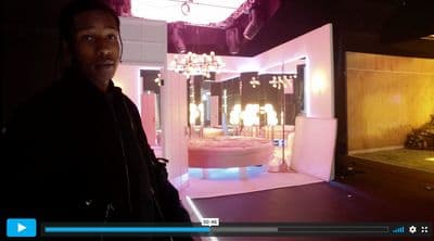 a man standing in front of a room with a chandelier