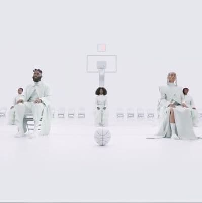 a group of people sitting on top of a basketball court