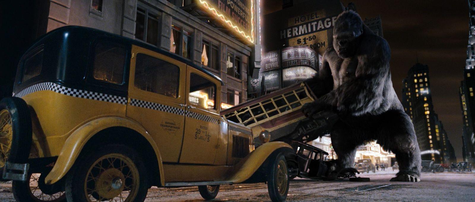 a big bear standing next to a yellow truck