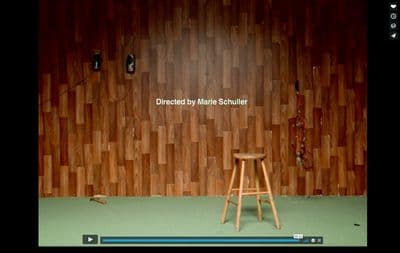 a wooden stool sitting in front of a wooden wall