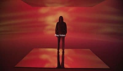 a person standing in front of a red light