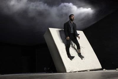 a man standing on top of a block of concrete