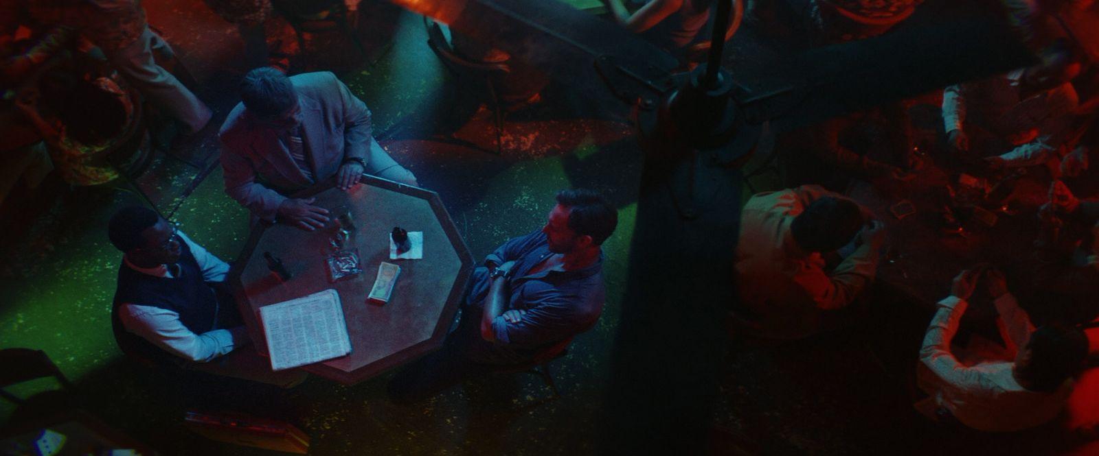 a group of people sitting around a wooden table