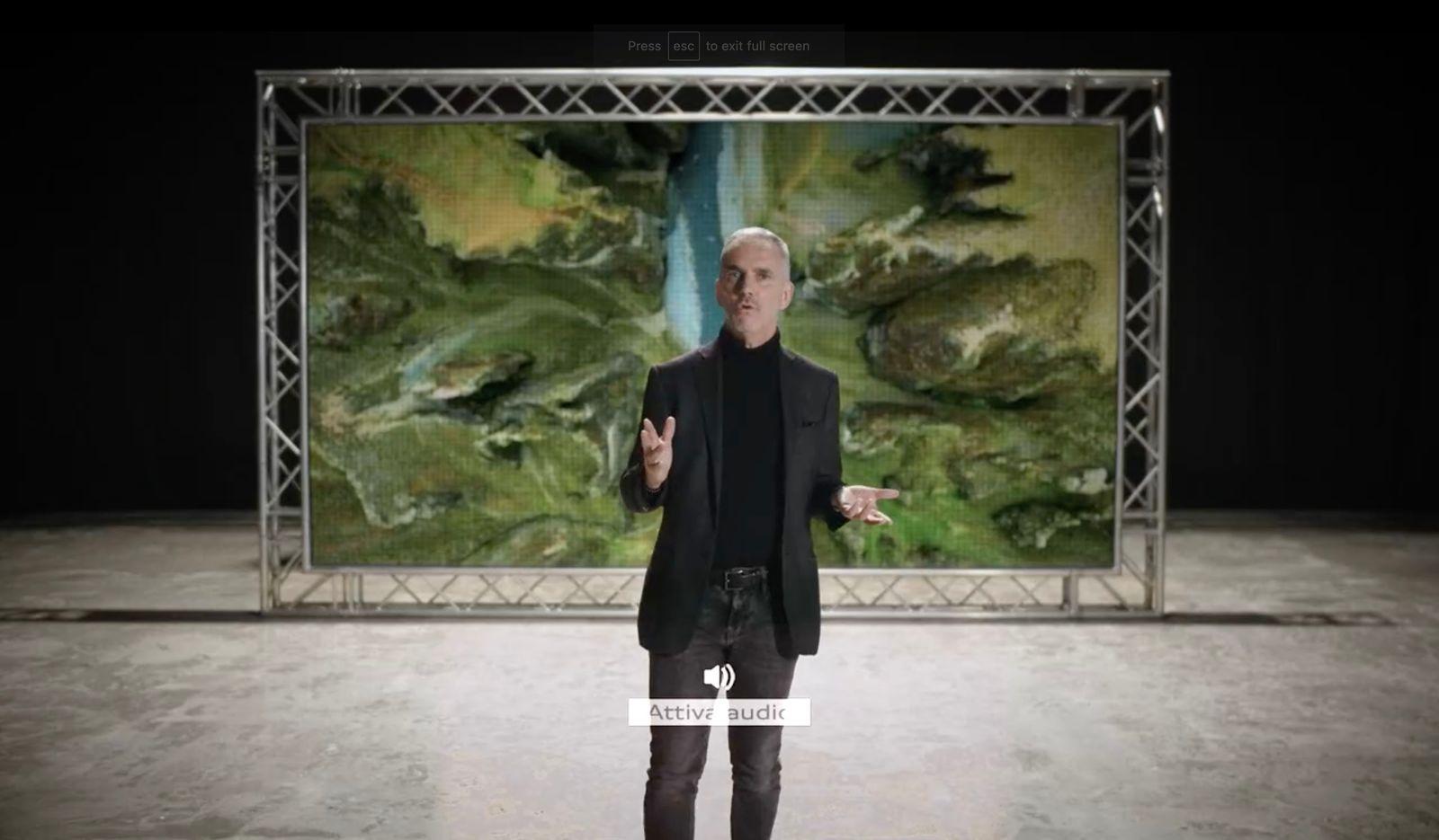 a man is standing in front of a painting