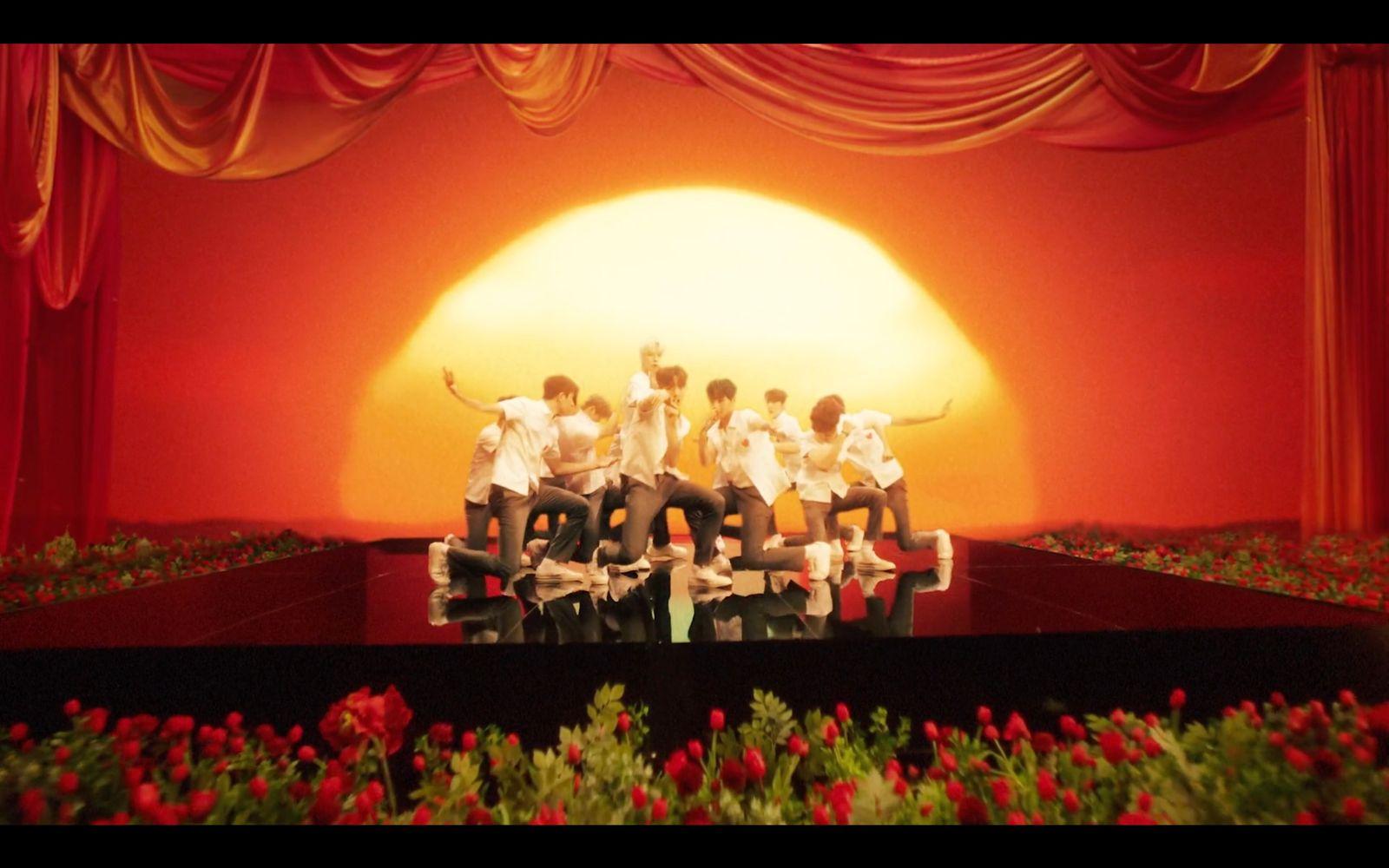 a group of people sitting on top of a stage