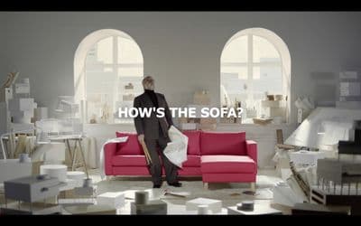 a man standing in front of a red couch