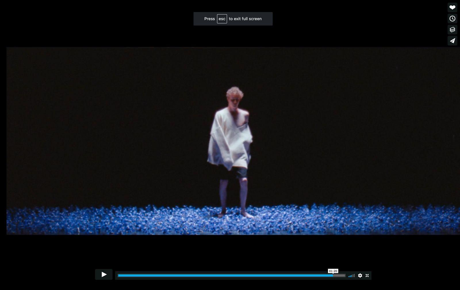 a woman in a white dress standing in the dark