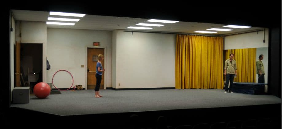 a person standing on a stage in a room