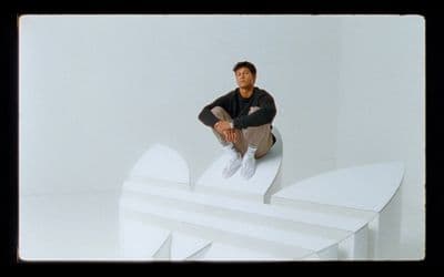 a man sitting on top of a white structure