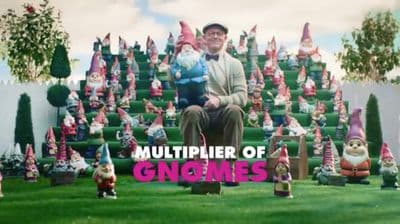 a man sitting on top of a pile of gnomes