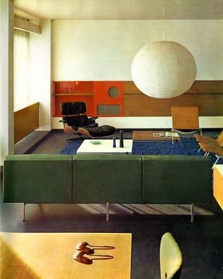 a living room with a couch a chair and a lamp