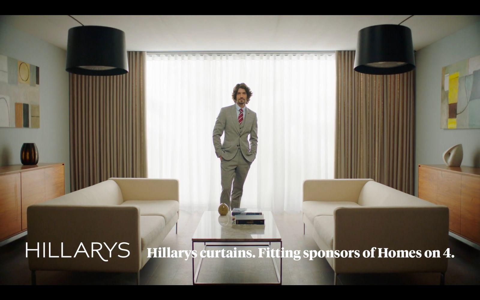 a man in a suit standing in a living room
