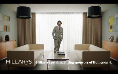 a man in a suit standing in a living room