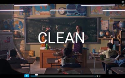 a classroom filled with students and a teacher standing in front of a chalkboard