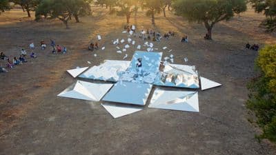 a group of people sitting on top of a field