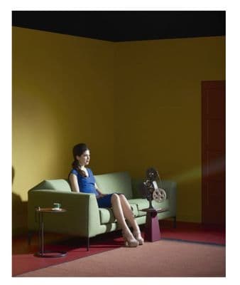 a woman sitting on a couch in a room