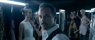a man standing in front of a mirror in a room