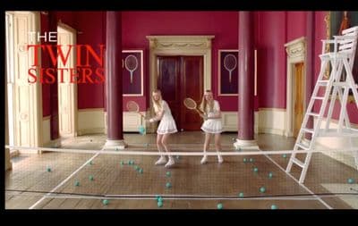 two girls in a room with tennis rackets