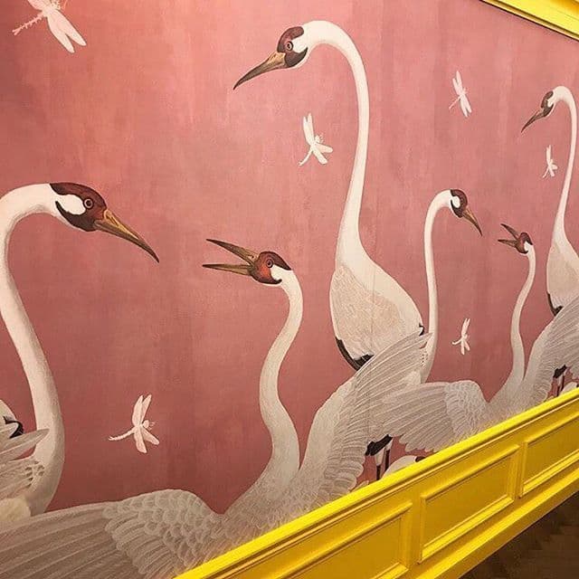 a painting of a group of birds on a wall
