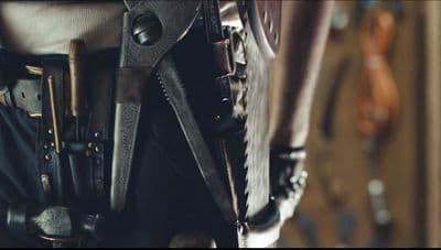 a close up of a person holding a pair of scissors