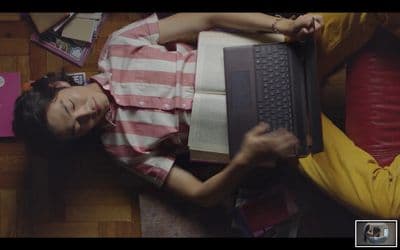 a person laying on the floor with a laptop